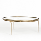 Olivia Glass Top Coffee Table with a brass finish on a mild steel frame. Sleek, modern coffee table is perfect for contemporary living rooms.